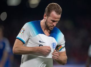 Harry Kane of England kisses the England badge after scoring the second goal and becoming England's all time record goalscorer during the UEFA EURO 2024 qualifying round group C match between Italy and England at Stadio Diego Armando Maradona on March 23, 2023 in Naples, Italy.
