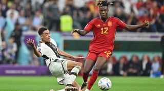 Germany's Jamal Musiala tackles Spain's Nico Williams, both impressive at Euro 2024, previously met at the 2022 World Cup.